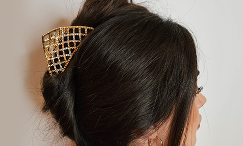 Elegant Golden Hair Clip in a Stylish Updo